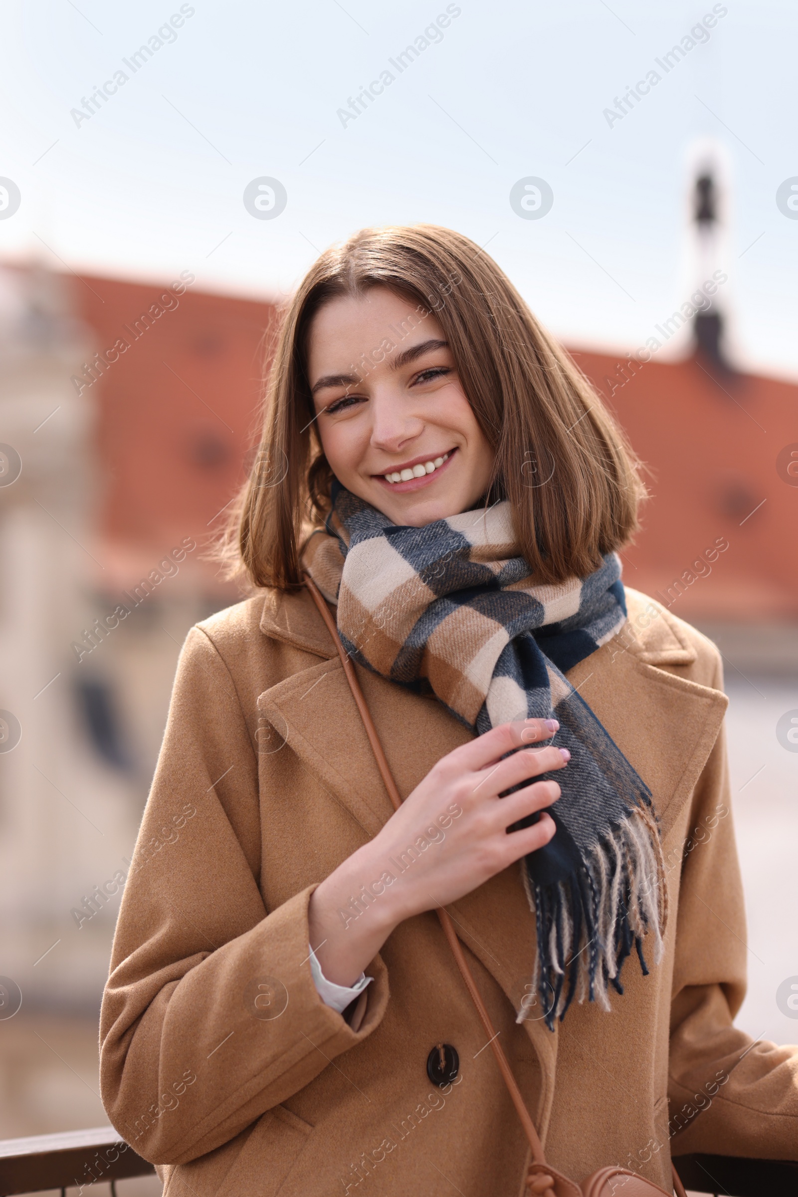 Photo of Beautiful woman in warm scarf on city street