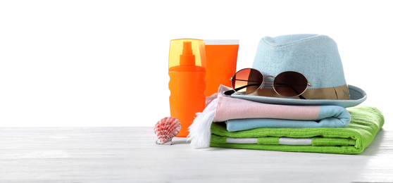 Photo of Different beach objects on wooden table against white background. Space for text