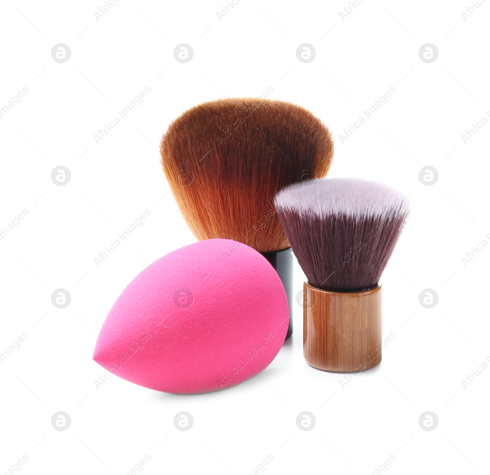 Photo of Makeup brushes with sponge of professional artist on white background