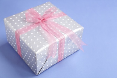 Beautifully decorated gift box on color background