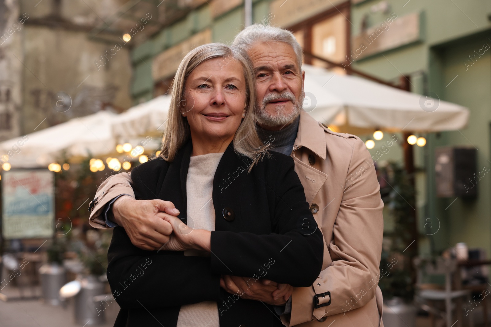 Photo of Portrait of affectionate senior couple on city street