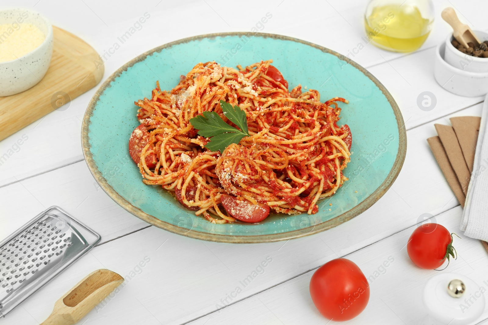 Photo of Beautiful composition with spaghetti on white wooden table in studio. Food stylist