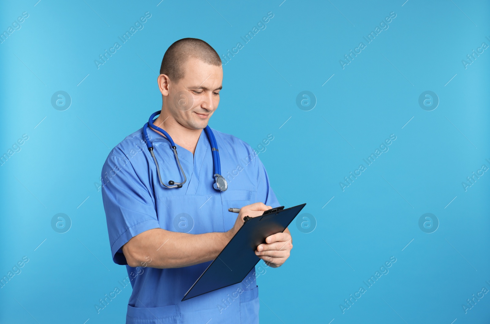 Photo of Portrait of medical assistant with stethoscope and clipboard on color background. Space for text