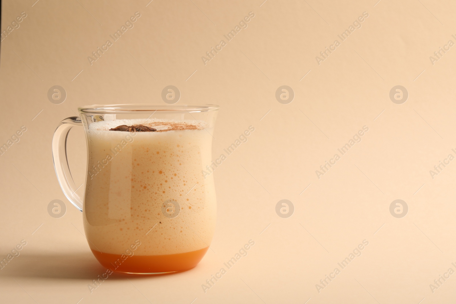 Photo of Delicious eggnog with anise on beige background. Space for text