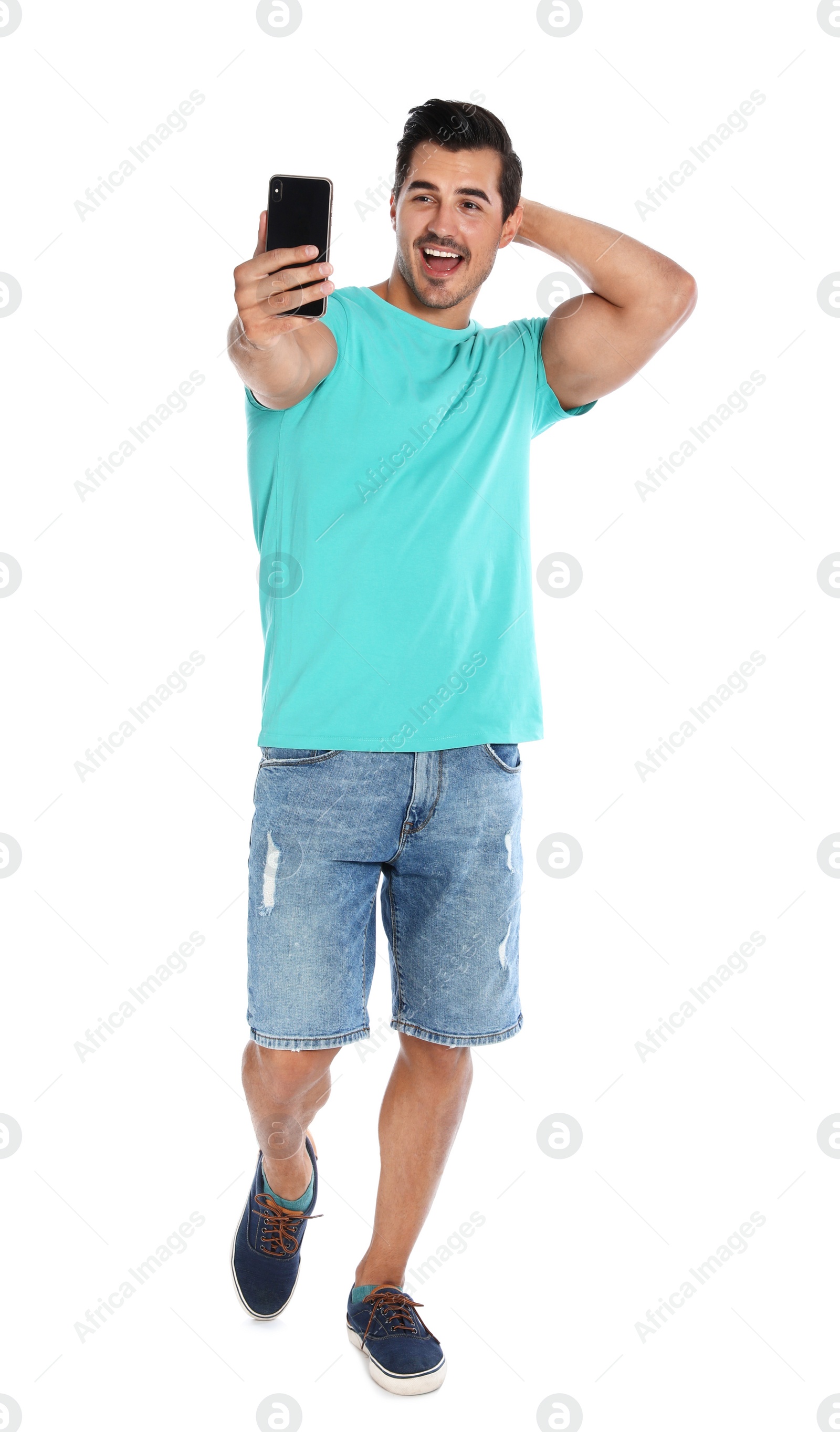 Photo of Happy young man taking selfie on white background