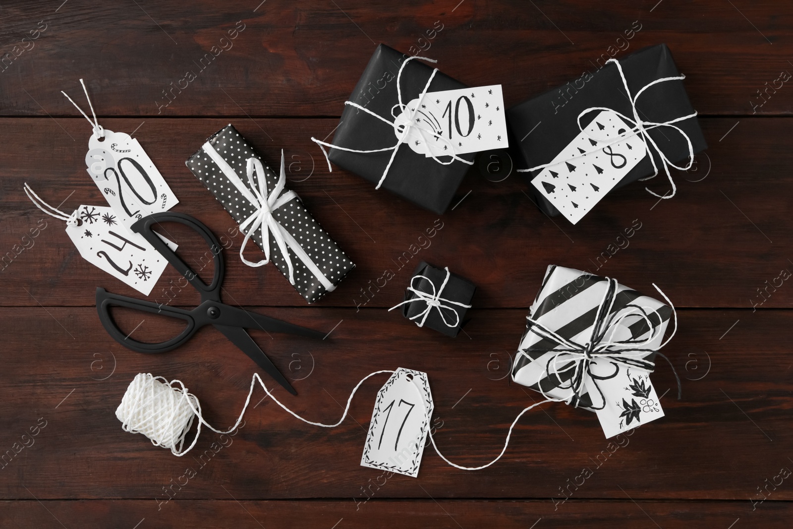 Photo of Flat lay composition with gift boxes on wooden table. Creating advent calendar