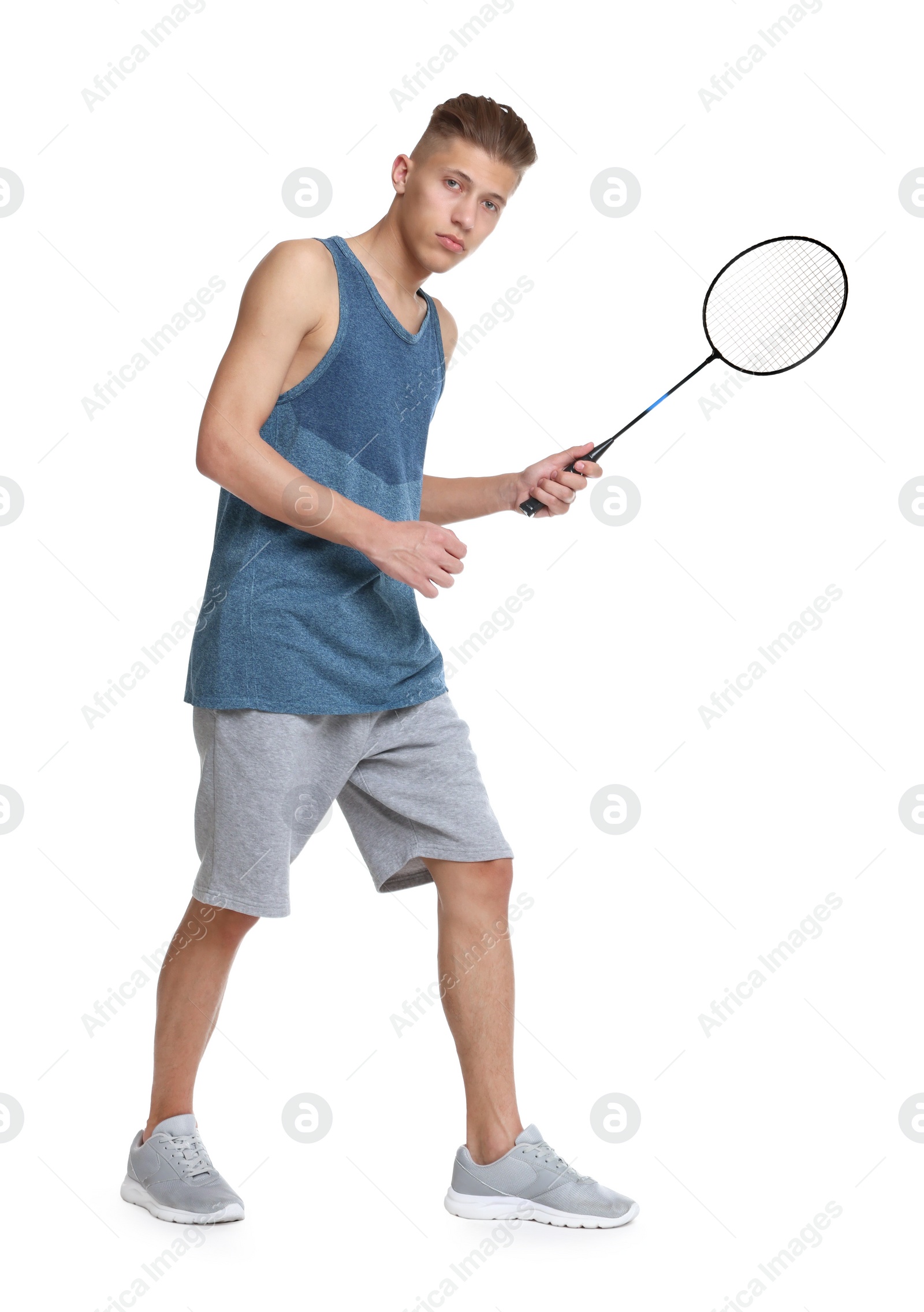 Photo of Young man playing badminton with racket on white background
