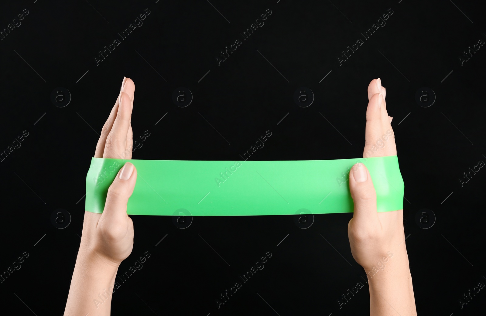 Photo of Woman with fitness elastic band on black background, closeup