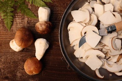 Photo of Flat lay composition with mushrooms and knife on wooden table