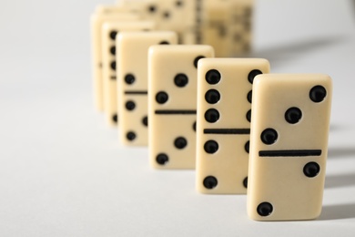 Photo of Domino tiles on white background, closeup. Space for text