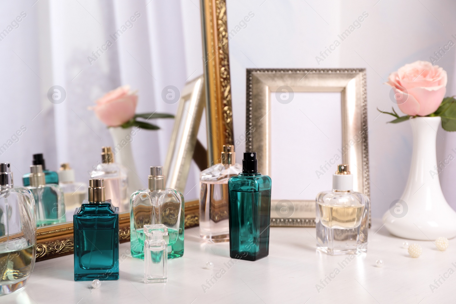 Photo of Perfume bottles on dressing table