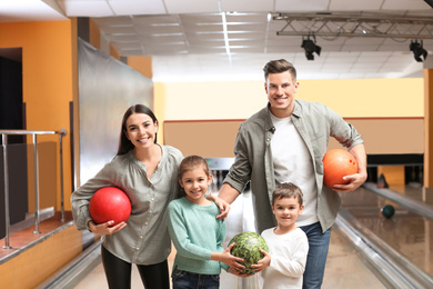 Happy family spending time together in bowling club