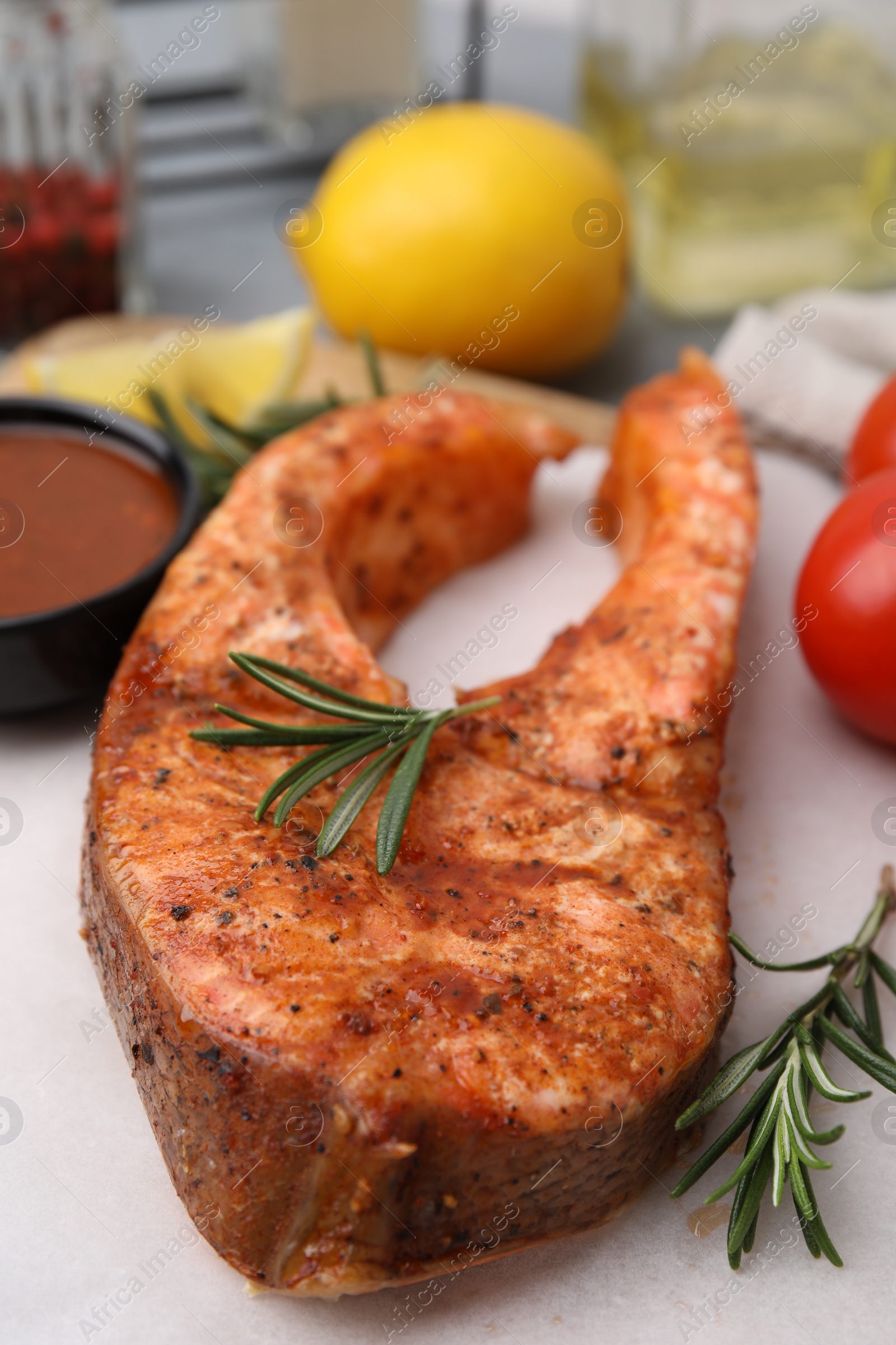 Photo of Fresh marinade and cooked fish on table, closeup