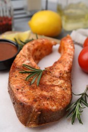 Fresh marinade and cooked fish on table, closeup