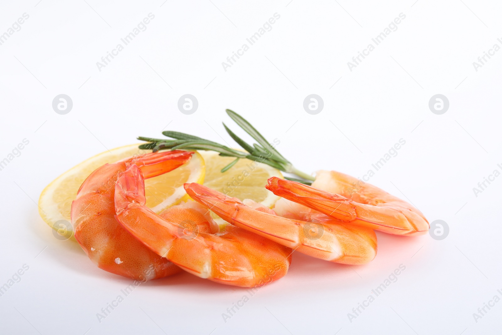 Photo of Delicious cooked shrimps, lemon and rosemary isolated on white