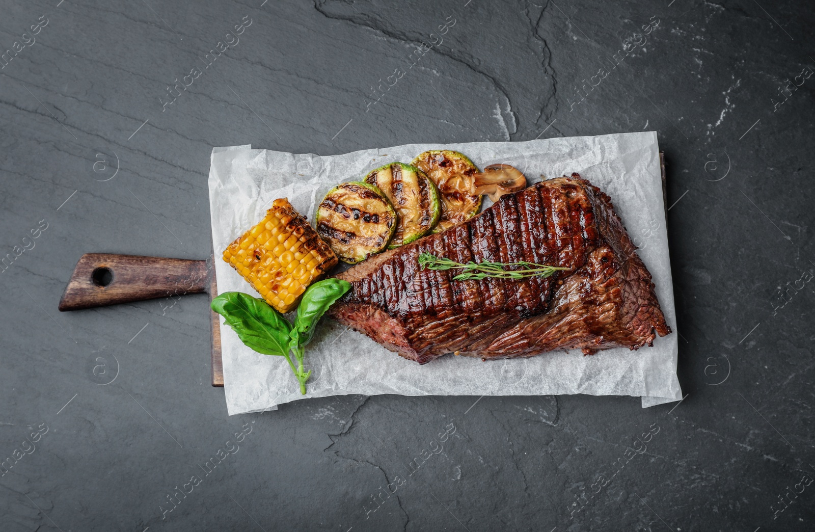 Photo of Delicious beef tenderloin served on grey table, top view