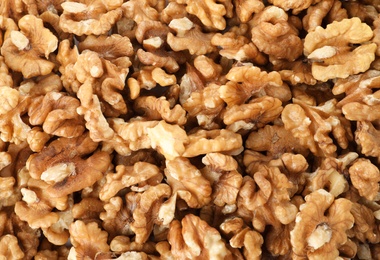 Many shelled walnuts as background, top view