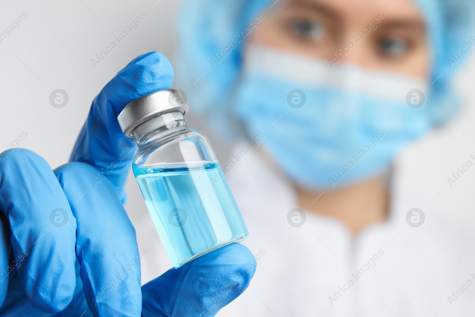 Photo of Doctor holding vial with medication, closeup. Vaccination and immunization