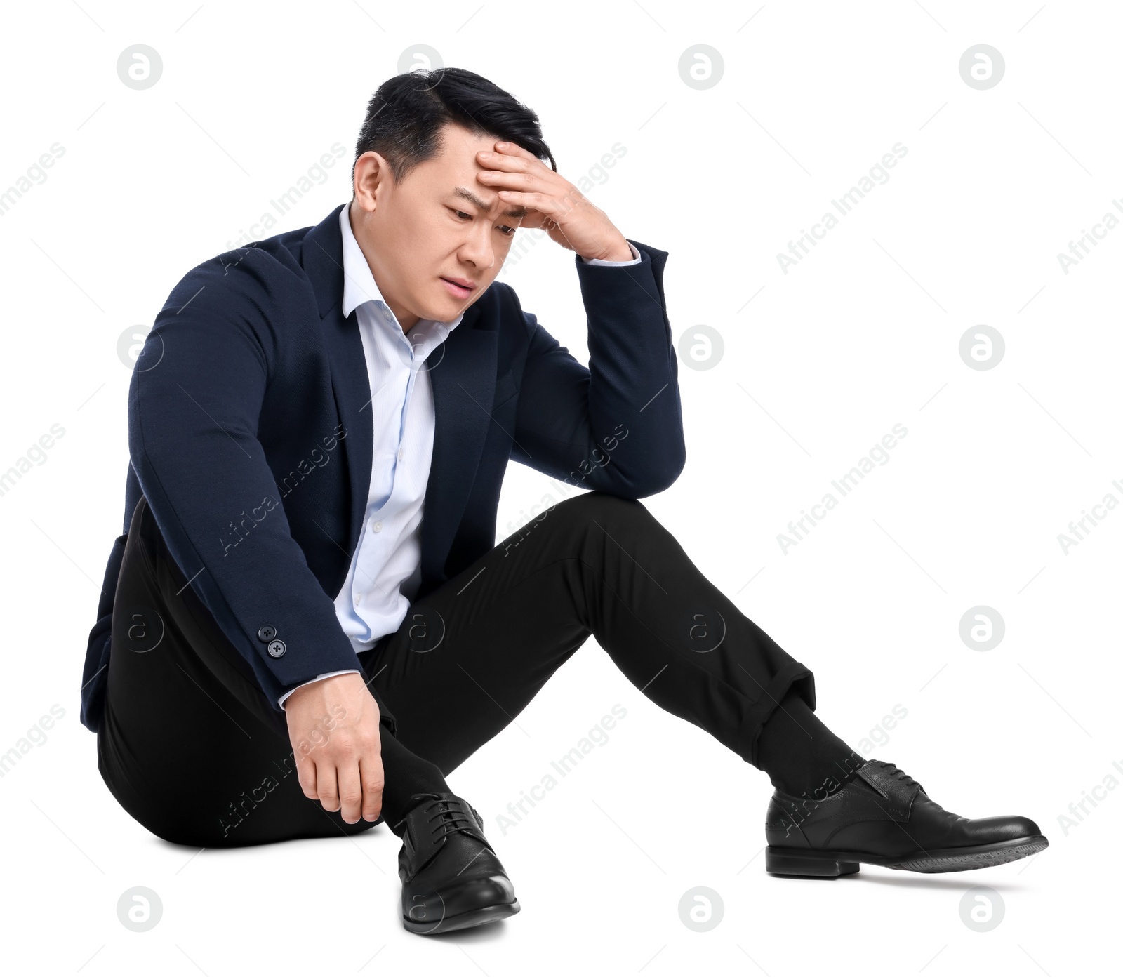 Photo of Tired businessman in suit sitting on white background