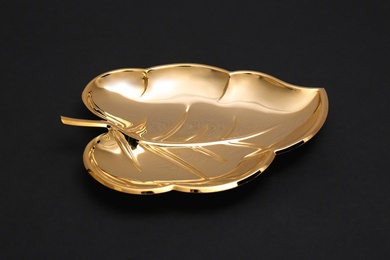 Photo of Gold leaf shaped bowl on black background