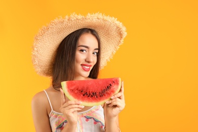 Photo of Beautiful young woman posing with watermelon on color background