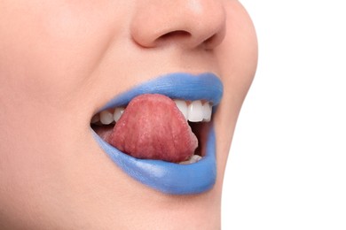 Woman with blue lipstick showing her tongue on light background, closeup. Space for text