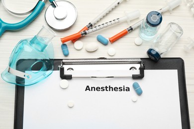 Photo of Flat lay composition of clipboard with word Anesthesia and drugs on white wooden table