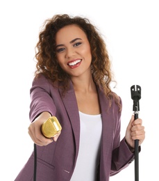 Photo of Curly African-American woman in suit with microphone on white background