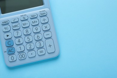 Photo of Modern calculator on light blue background, top view. Space for text