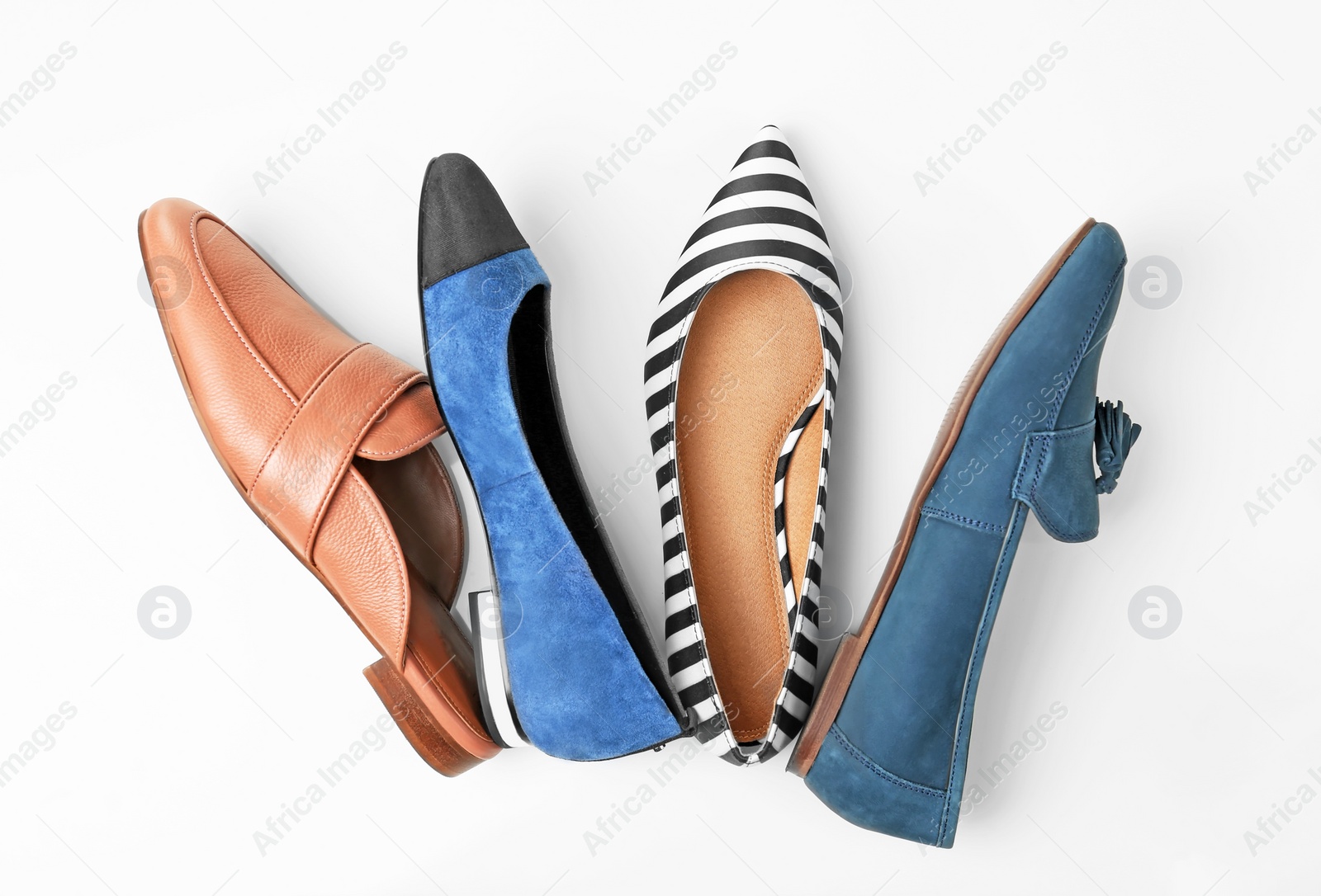 Photo of Different female shoes on white background, top view