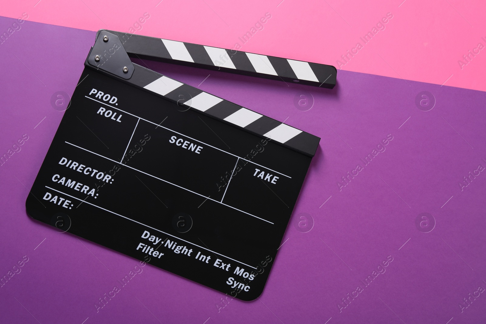 Photo of Clapperboard on color background, top view. Space for text