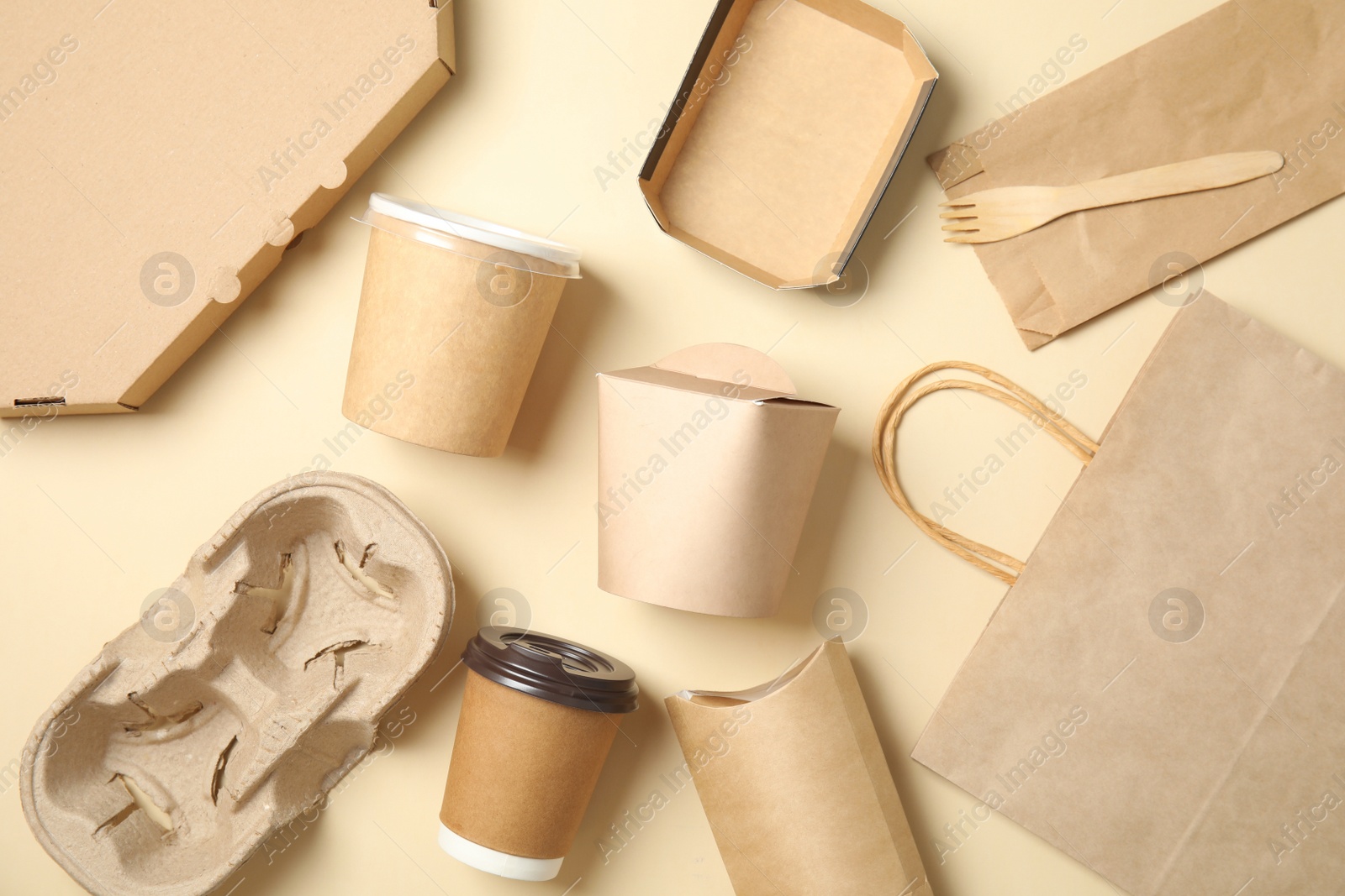 Photo of Different containers for mock up design on beige background, flat lay. Food delivery service