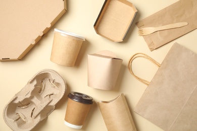 Different containers for mock up design on beige background, flat lay. Food delivery service