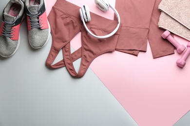 Photo of Flat lay composition with sportswear and equipment on color background, space for text. Gym workout