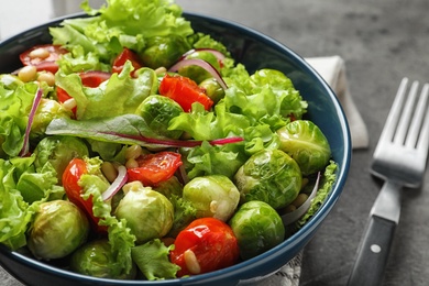 Bowl of salad with Brussels sprouts on table, closeup