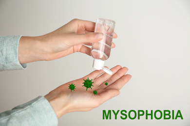 Image of Woman applying antiseptic gel on hands, closeup. Mysophobia