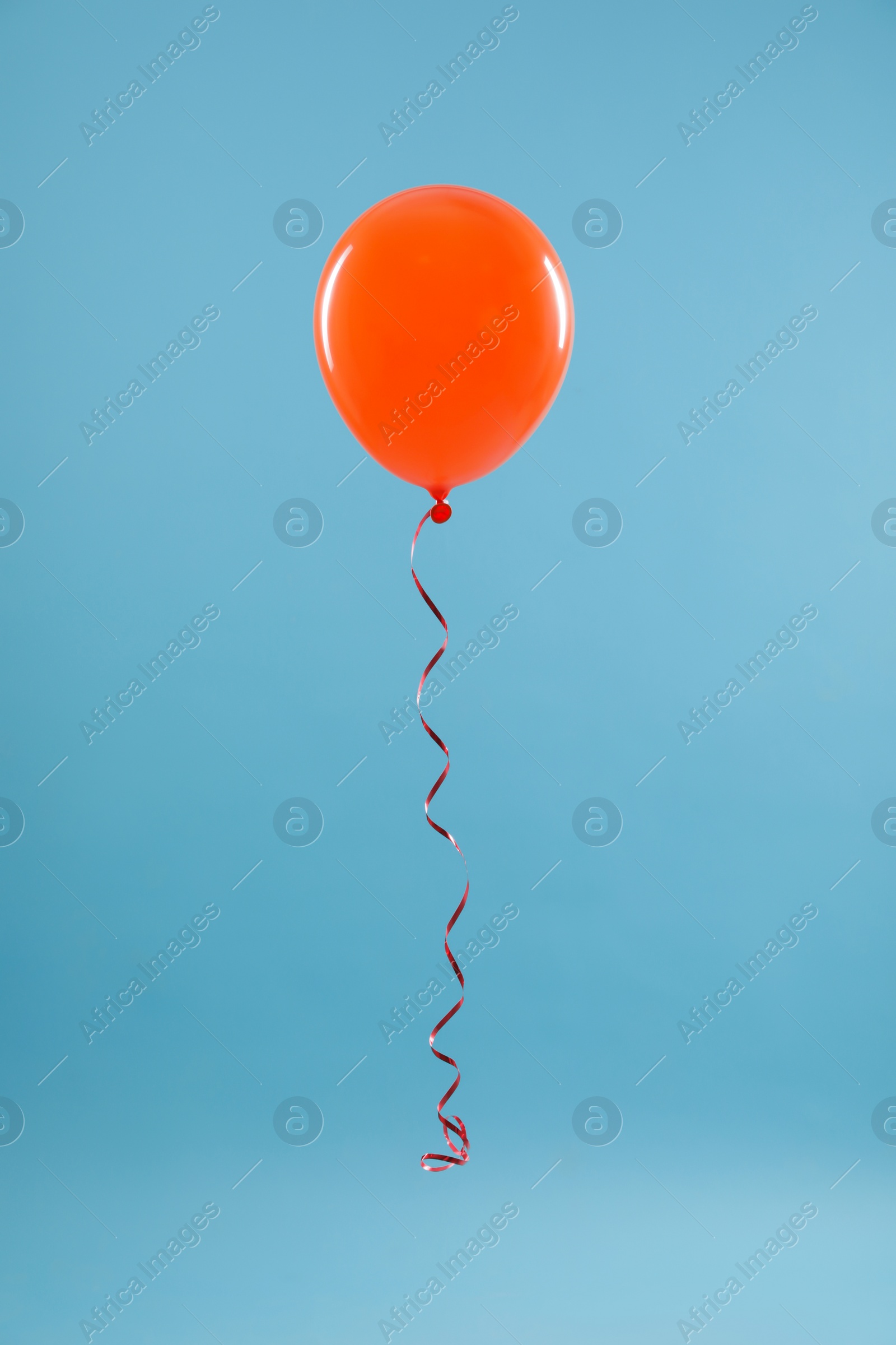 Photo of Bright balloon on color background. Celebration time