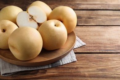 Cut and whole apple pears on wooden table