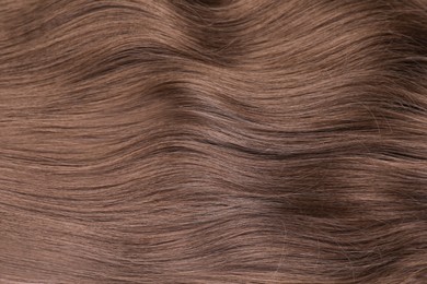 Photo of Beautiful brown hair as background, top view