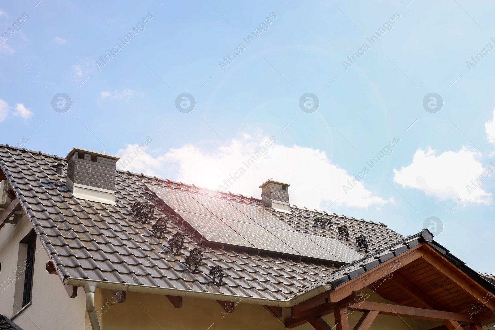 Photo of House with installed solar panels on roof. Alternative energy