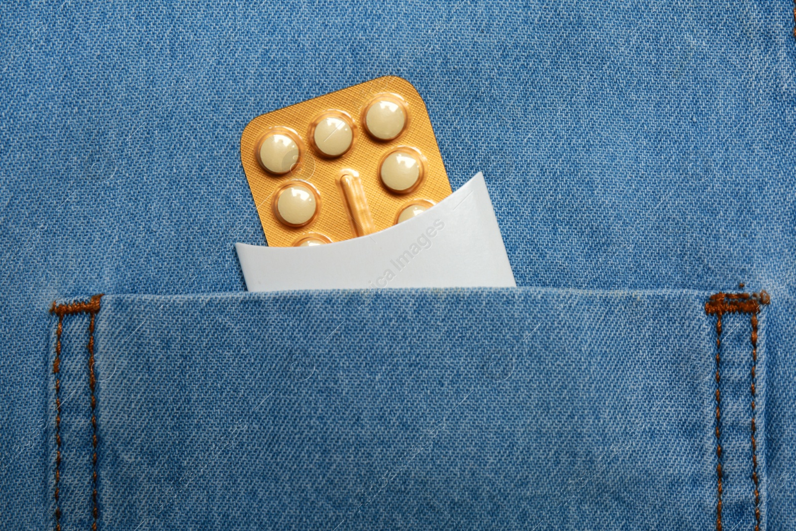 Photo of Birth control pills in pocket of jeans, closeup