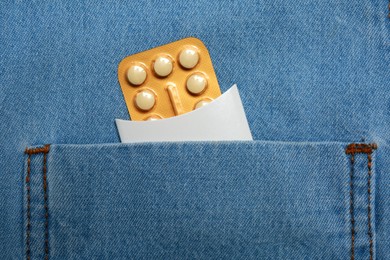 Photo of Birth control pills in pocket of jeans, closeup