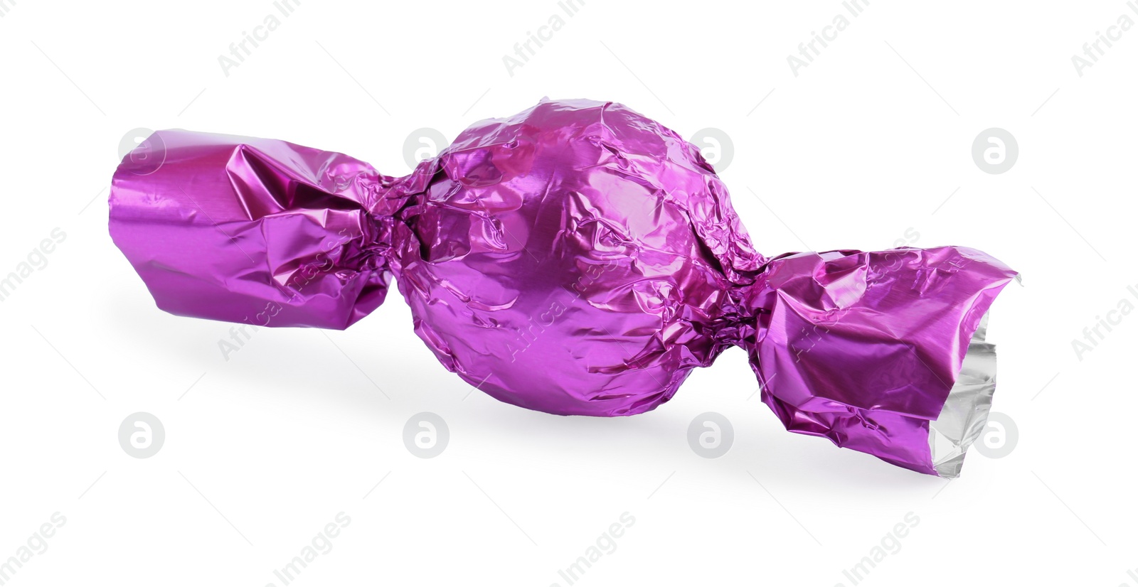 Photo of Tasty candy in violet wrapper isolated on white