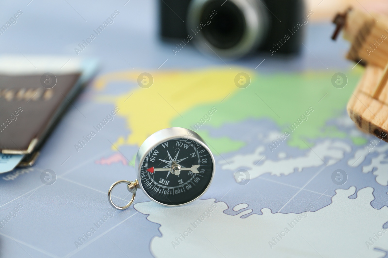 Photo of Compass and different items on world map. Trip planning