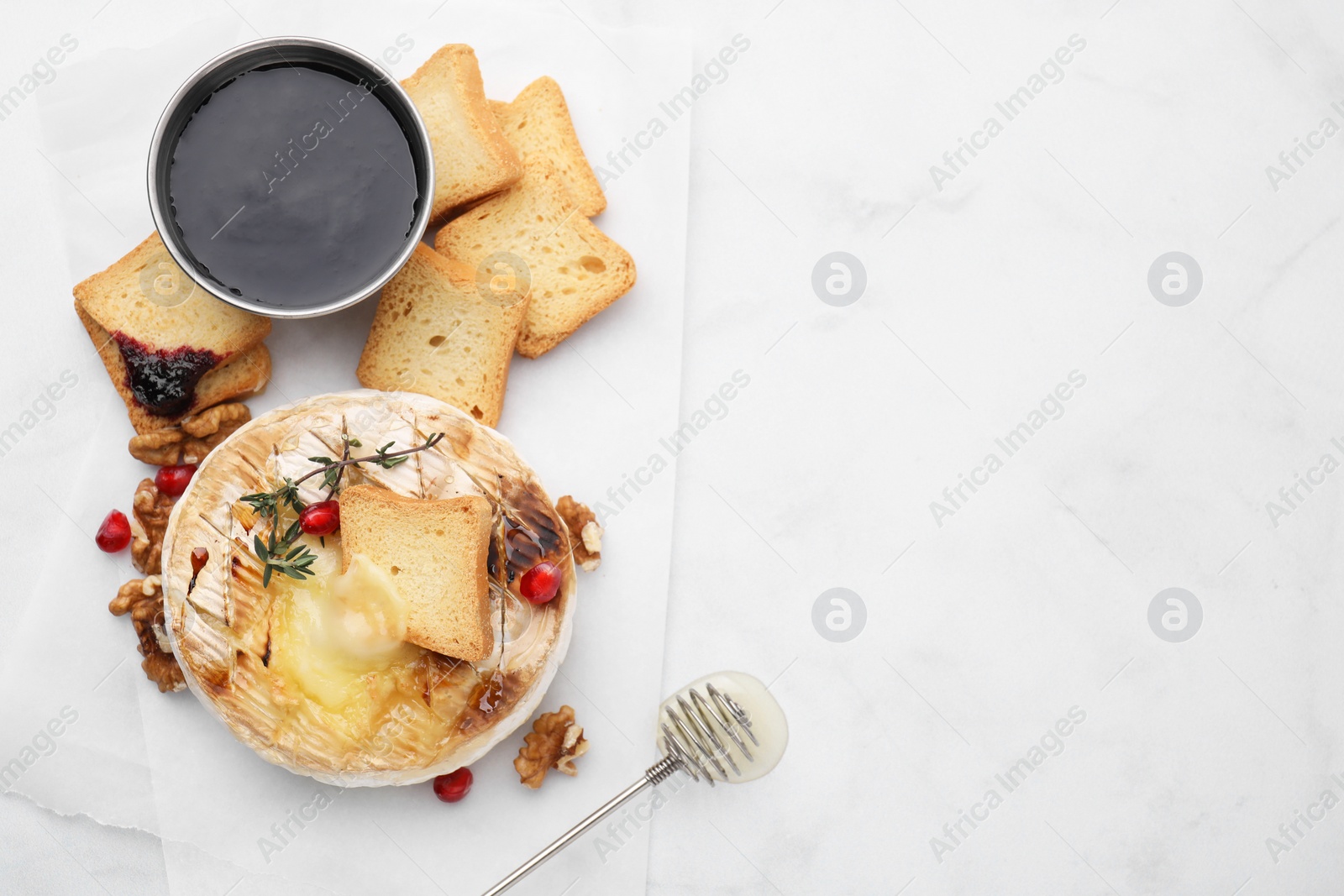 Photo of Flat lay composition with tasty baked camembert on white marble table. Space for text