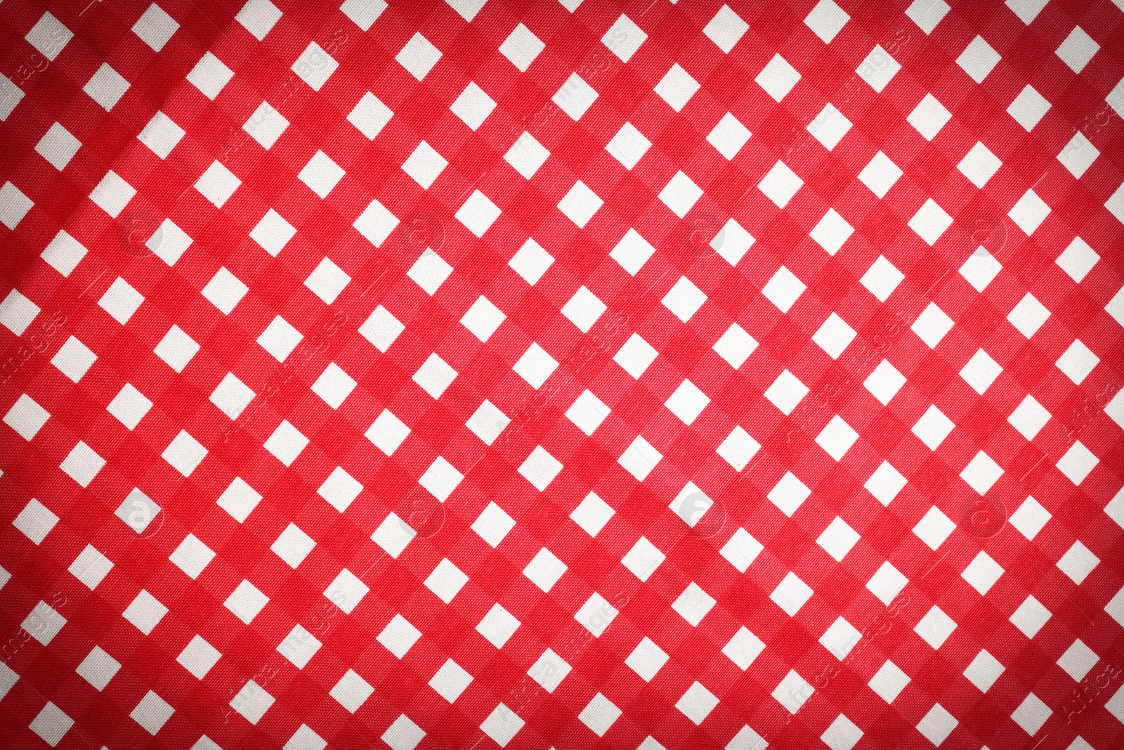 Image of Red and white tablecloth as background, vignette effect