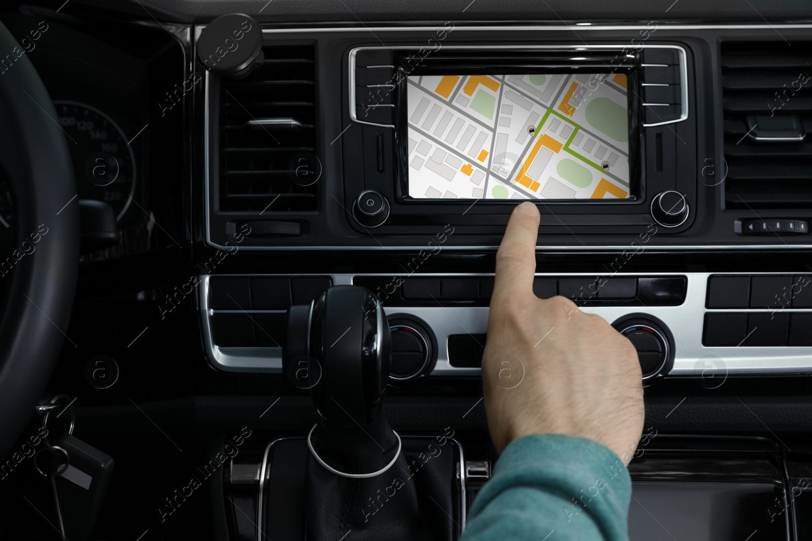 Image of Man using navigation system while driving car, closeup