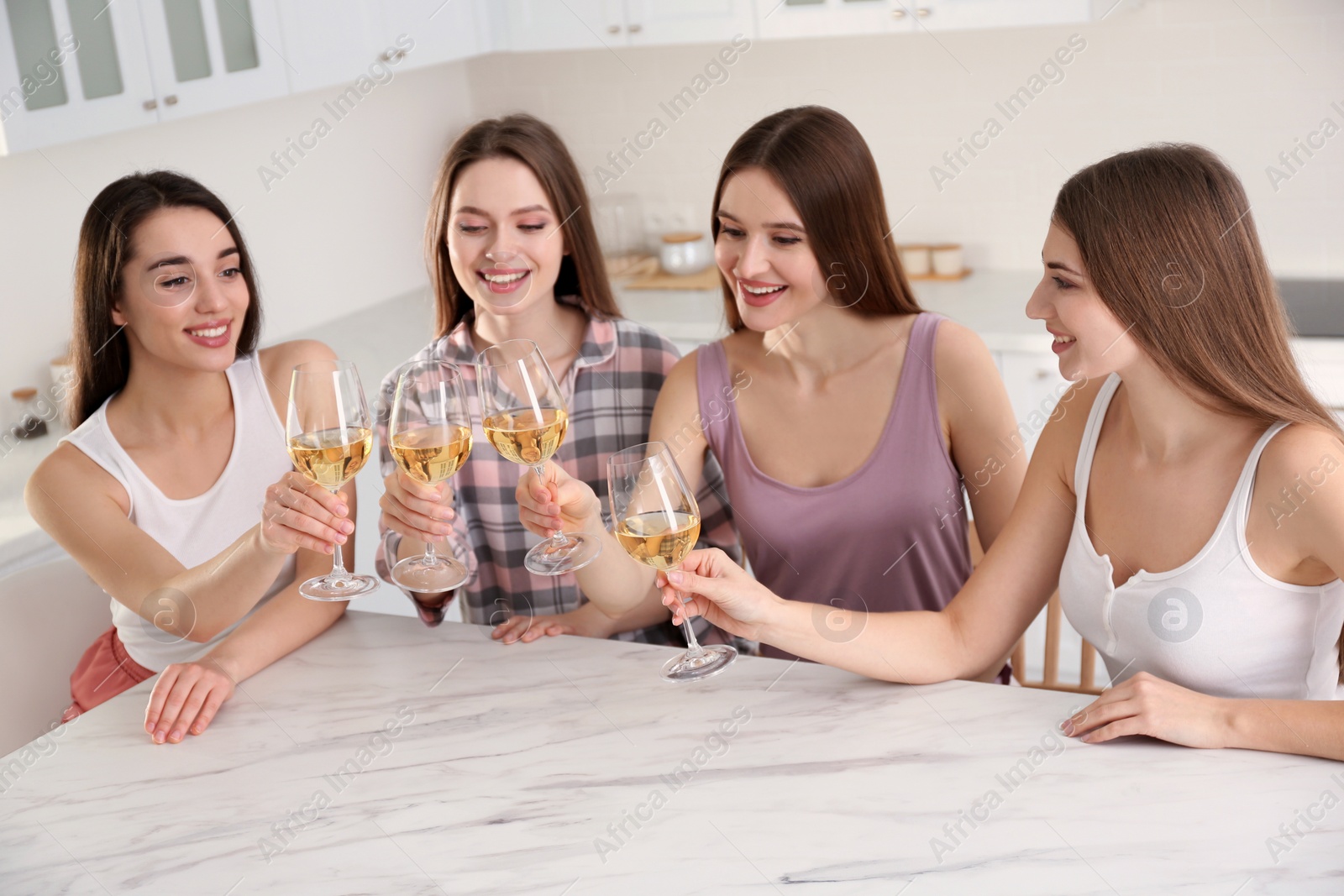 Photo of Beautiful young ladies toasting at home. Woman's Day