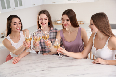 Photo of Beautiful young ladies toasting at home. Woman's Day