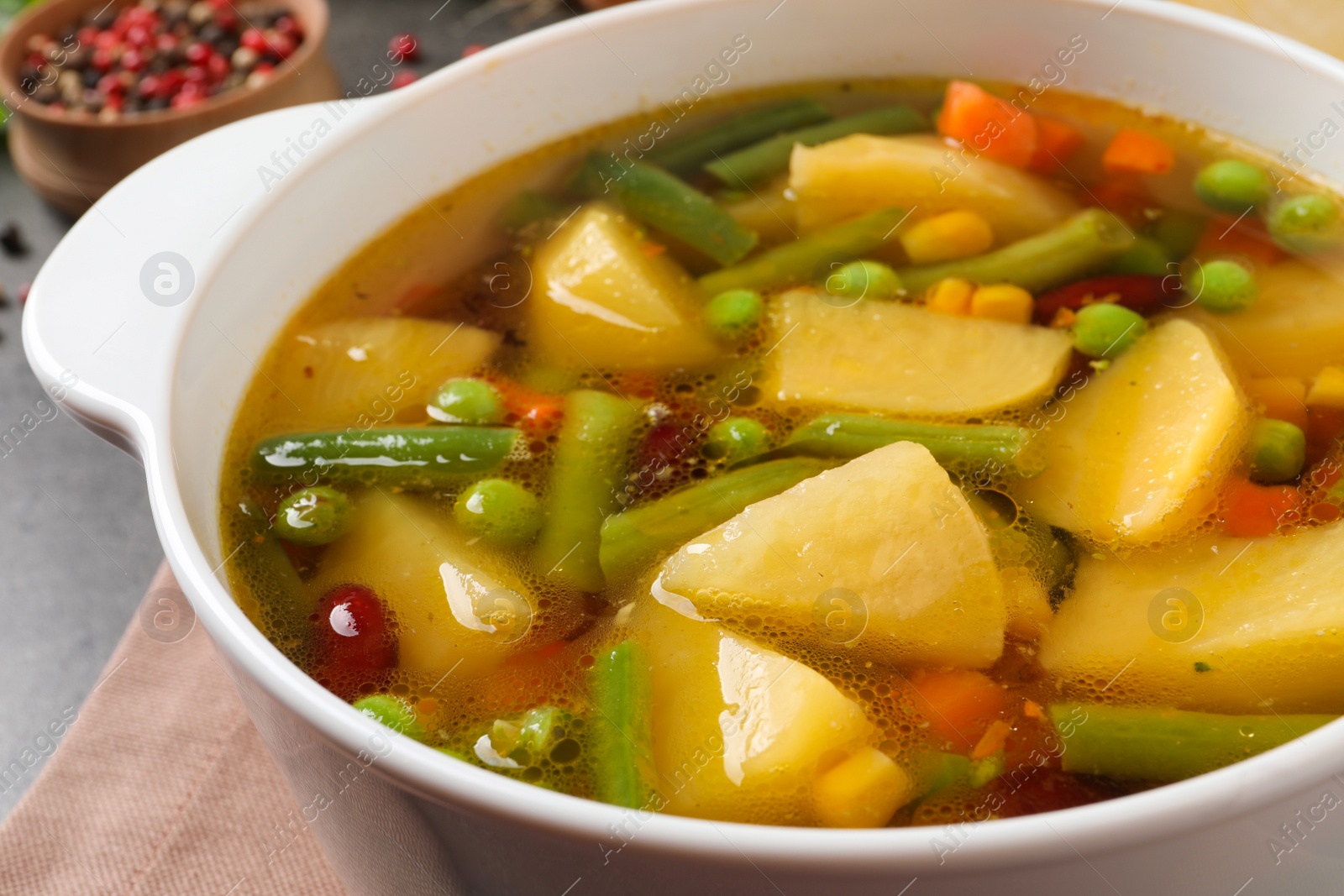 Photo of Bowl of delicious turnip soup on table, closeup